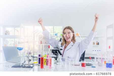 pretty scientist work reserching and cheerfully in chemical laboratory 61766978