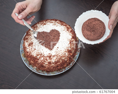 Decorating a cake for Valentines day. Handmade pie 61767004