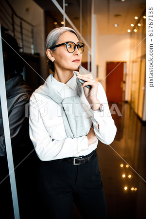Thoughtful elegant woman in the hall stock photo Thoughtful elegant woman in the hall stock photo 61767138