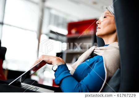 Tired businesswoman closing laptop and relaxing stock photo Tired businesswoman closing laptop and relaxing stock photo 61767229