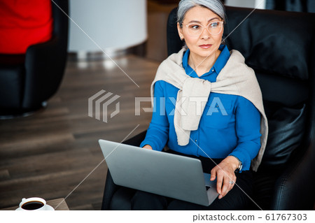 Serious woman and her modern gadget stock photo 61767303