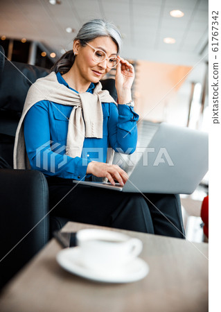 Using the glasses while working on laptop stock photo 61767342