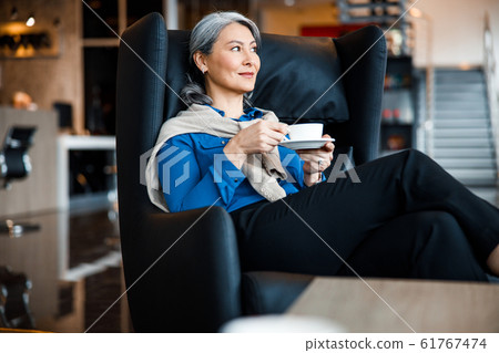 Pleased office worker with hot coffee stock photo Pleased office worker with hot coffee stock photo 61767474