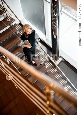 Top view of the stairs and woman walking down stock photo 61767649
