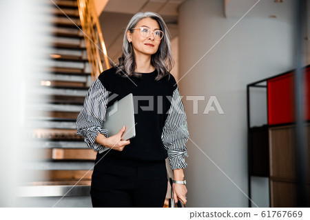 Beautiful smiling boss with modern laptop stock photo 61767669