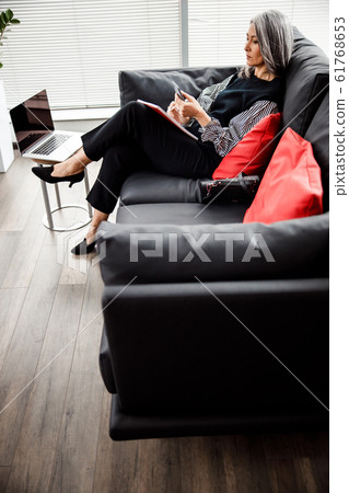 Serious businesswoman using modern smartphone stock photo Serious businesswoman using modern smartphone stock photo 61768653
