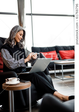 Beautiful businesswoman checking time at work stock photo 61768796