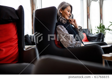 Thoughtful lady at work looking interested stock photo 61768835