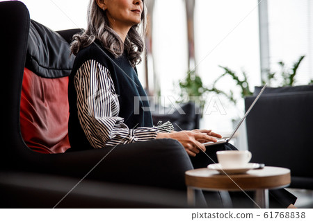 Cropped photo of woman with laptop stock photo Cropped photo of woman with laptop stock photo 61768838