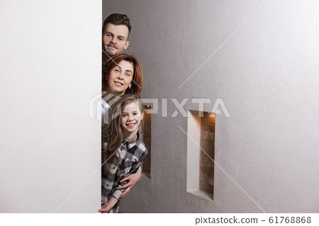 Tricky family peeks around the corner 61768868