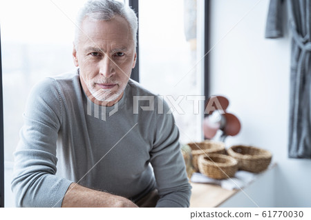 Calm mature man slightly smiling stock photo 61770030