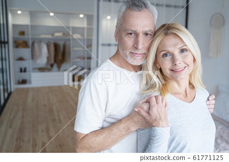 Smiling man with his woman in the bedroom stock photo 61771125