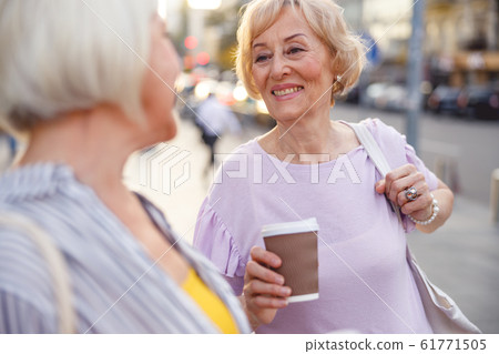 Woman telling good bye to her friend Woman telling good bye to her friend 61771505