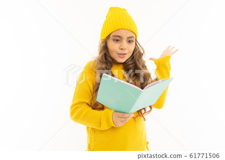 Happy caucasian girl in yellow hat and hoody read a book isolated on white background Happy caucasian girl in yellow hat and hoody read a book isolated on white background 61771506