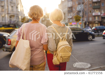 Friends looking at the cars on the road Friends looking at the cars on the road 61771556