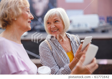 Woman sharing her impressions with a friend Woman sharing her impressions with a friend 61771642
