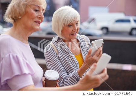 Two women having video calls with their children Two women having video calls with their children 61771643