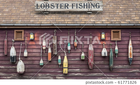 Closeup of colorful floats hanging outside a lobster fisherman's cottage 61771826