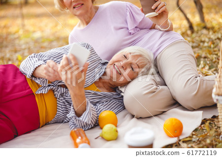 Cheerful ladies being relaxed on their picnic 61772119