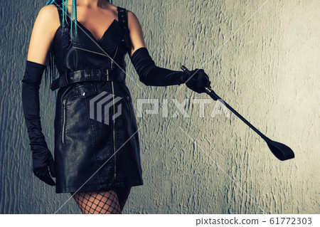 Dominant woman in a leather dress with a stack in Dominant woman in a leather dress with a stack in 61772303
