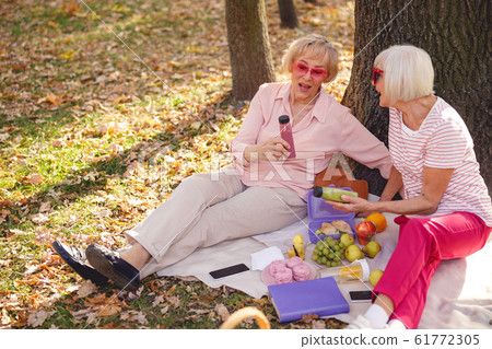 Happy woman telling her friend a story Happy woman telling her friend a story 61772305