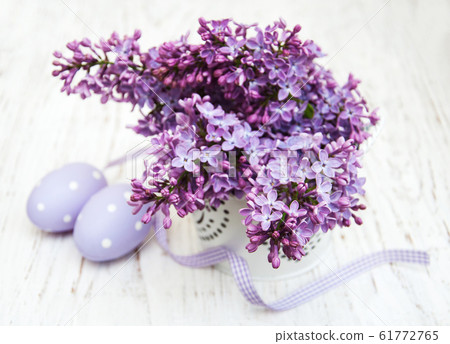 easter eggs and fresh lilac flowers 61772765