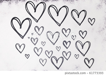 Texture of drawn hearts in black on a white background from flour. Valentine's Day. Texture of drawn hearts in black on a white background from flour. Valentine's Day. 61773393
