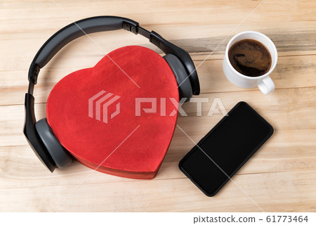 Heart box with headphones, phone and cup of coffee Heart box with headphones, phone and cup of coffee 61773464