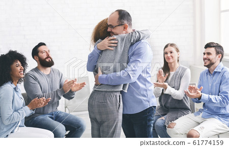 Positive people hugging during group therapy session in rehab Positive people hugging during group therapy session in rehab 61774159