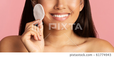 Face care concept. Girl cleaning face skin with cotton pad Face care concept. Girl cleaning face skin with cotton pad 61774943