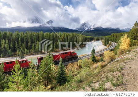 Red train long freight on railway passing in 61775179