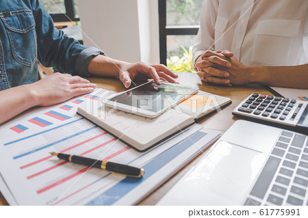Business team brainstorming and discussing with financial data and report graph. Business team brainstorming and discussing with financial data and report graph. 61775991