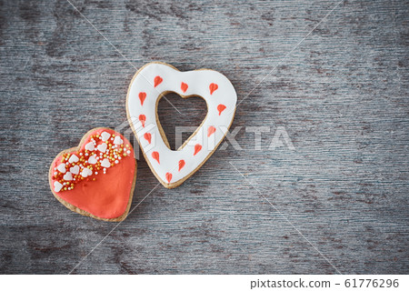 Two decorated heart shape cookies on the gray Two decorated heart shape cookies on the gray 61776296