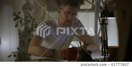 Artist drawing at table 61777607