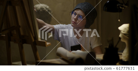 Boy using smartphone and drawing Boy using smartphone and drawing 61777631