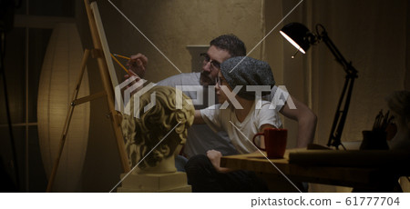 Father and son studying sculpture Father and son studying sculpture 61777704