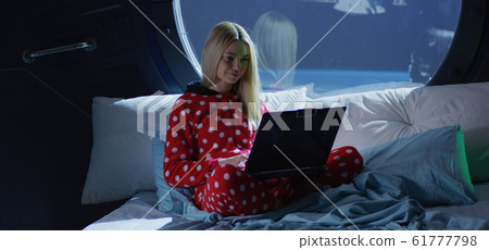 Woman having video call in a spaceship 61777798