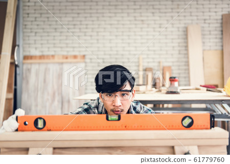 Carpenter Man is Working Timber Woodworking in Carpentry Shop 61779760