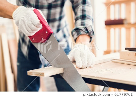 Carpenter Man is Working Timber Woodworking in Carpentry Shop 61779761