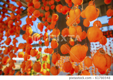 Dried persimmon and bell tower 61780348