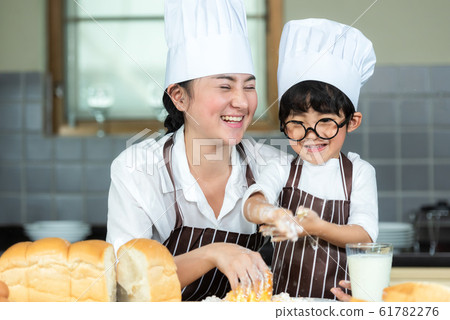 Cooking Family. Chef mother and kid boy cooking Cooking Family. Chef mother and kid boy cooking 61782276