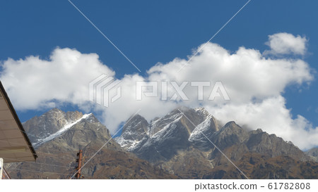 Panoramic movement of fuzzy floating Clouds flowing over Mountain Panoramic movement of fuzzy floating Clouds flowing over Mountain 61782808