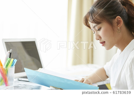 Young woman desk work scene 61783639
