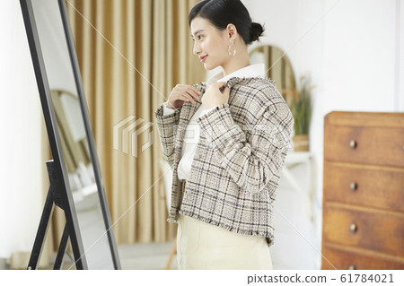 A woman dressed up in her room 61784021