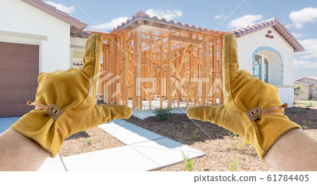 Male Contractor Hands Framing Unfinished Section of Construction Sketch 61784405