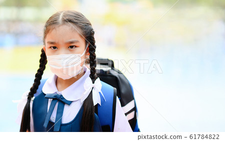School Girl wearing mouth mask against air smog 61784822