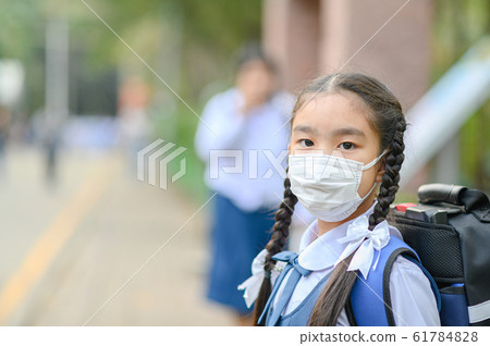 School Girl wearing mouth mask against air smog School Girl wearing mouth mask against air smog 61784828