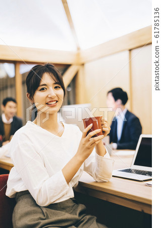 Business woman drinking coffee between work 61785136