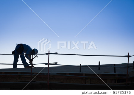 Construction Workers Silhouette on Rooftop Construction Workers Silhouette on Rooftop 61785376