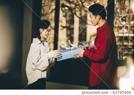 A couple giving gifts A couple giving gifts 61785408